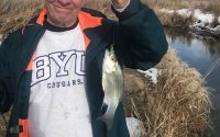Kirk Rasmussen is holding a white bass caught on Utah Lake.