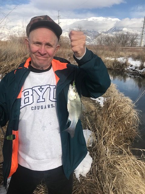 Kirk Rasmussen is holding a white bass caught on Utah Lake.